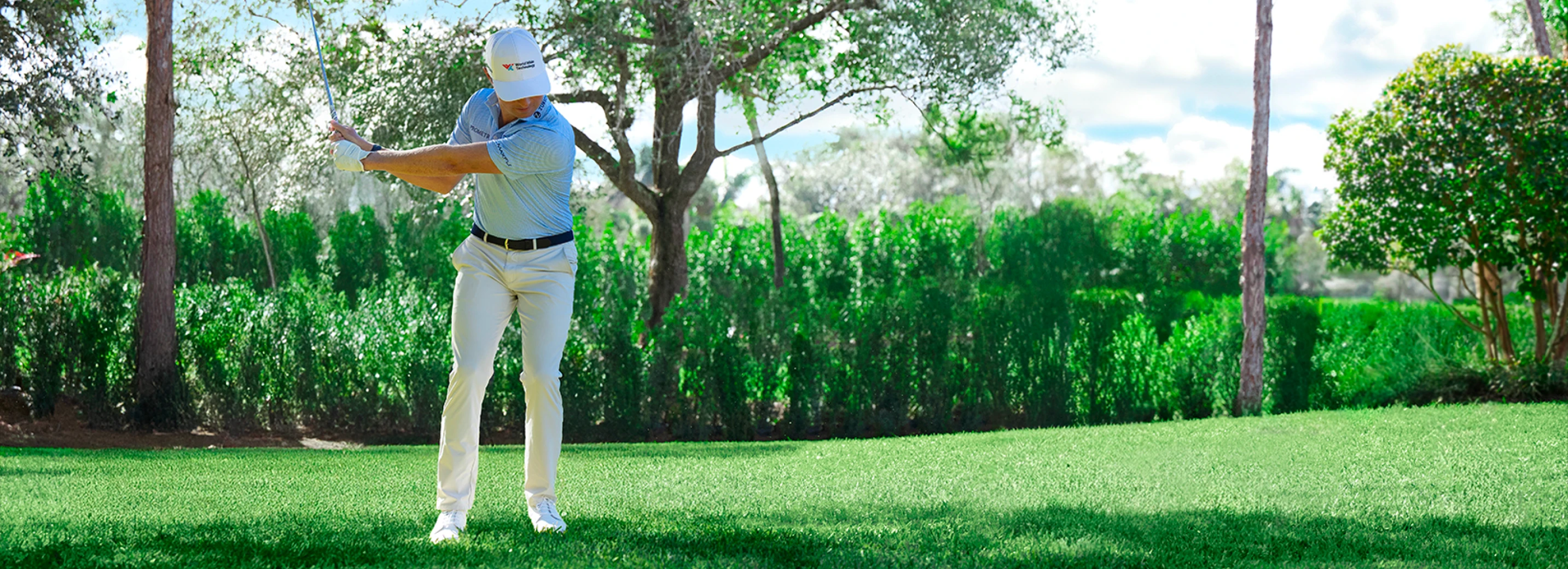 Ben Griffin swinging a golf club on a golf course quality lawn