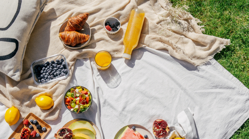 Overhead image of a spring breakfast picnic on a lawn 