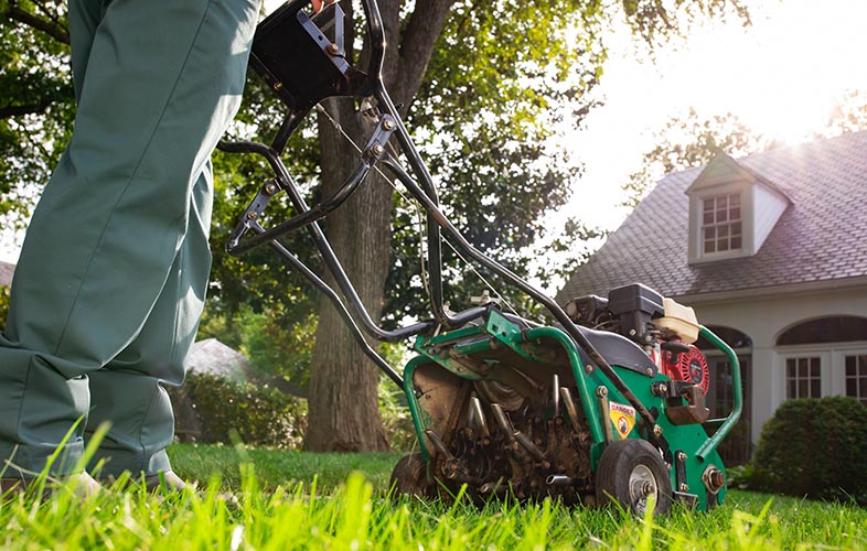 TruGreen specialist completing aeration service