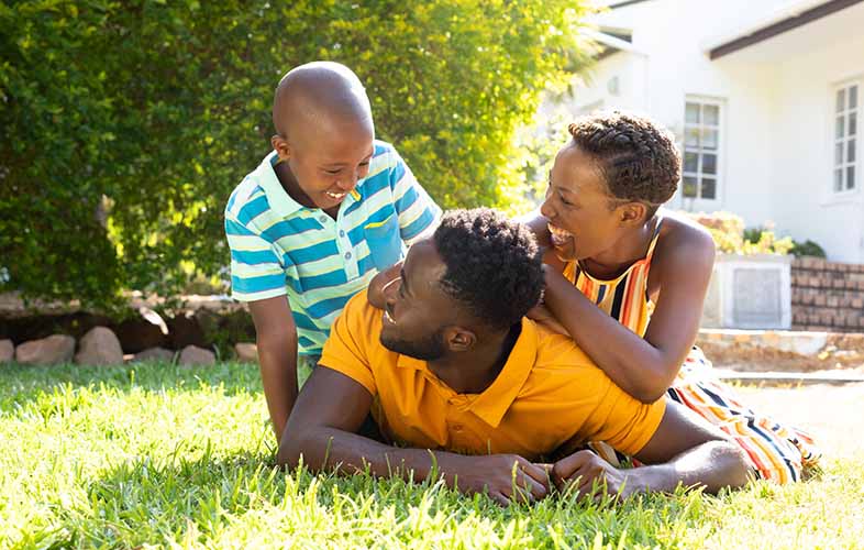 Family having fun on green lawn