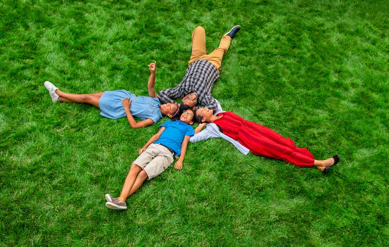 Family laying on grass