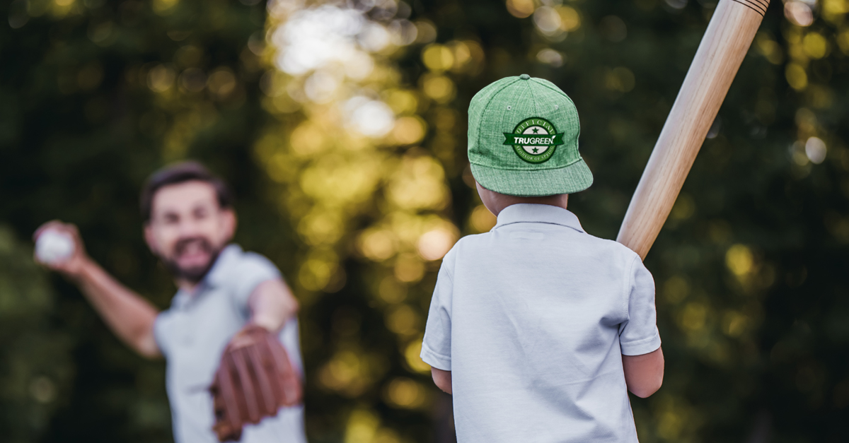 Family playing baseball on lawn